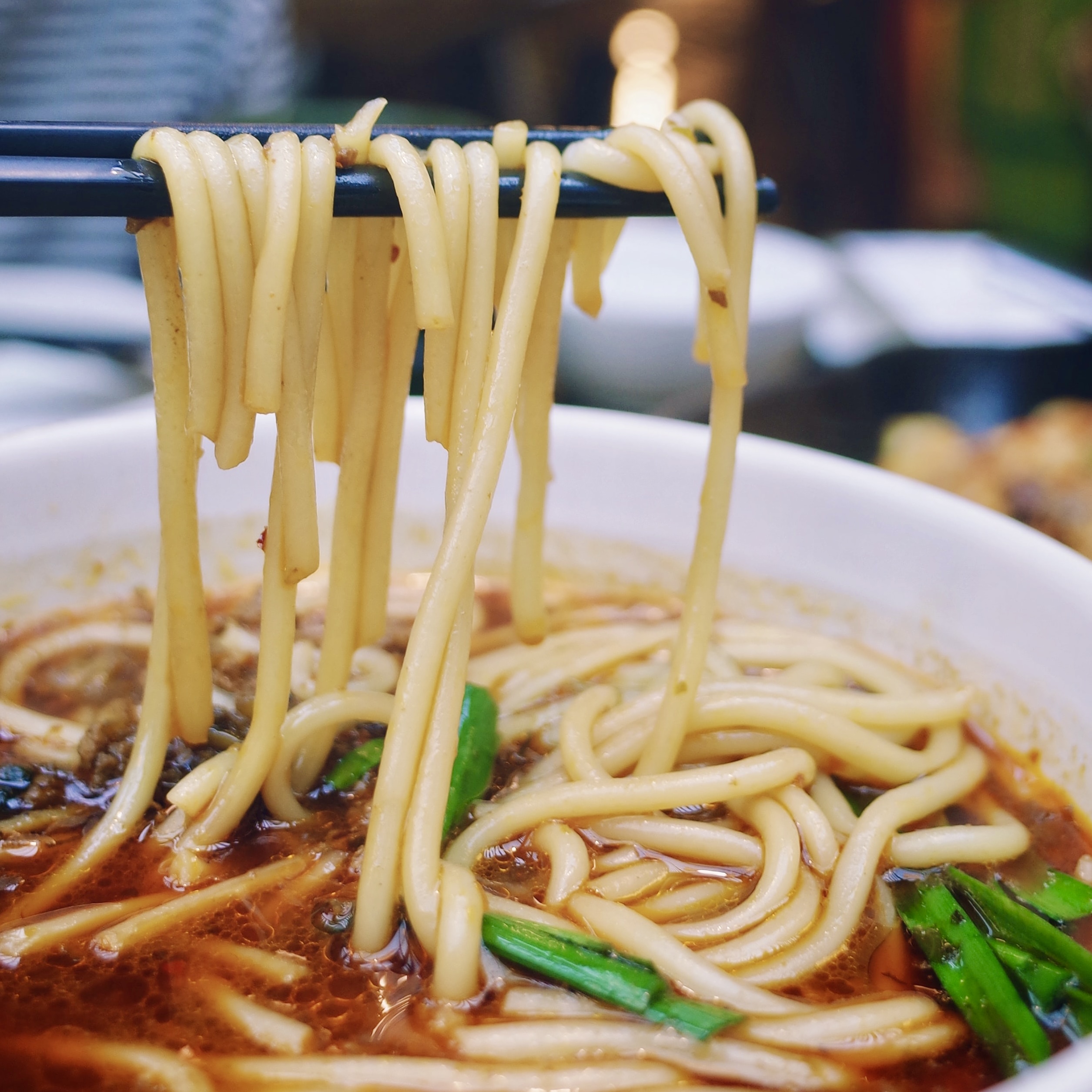 Image of noodles being picked up with chopsticks